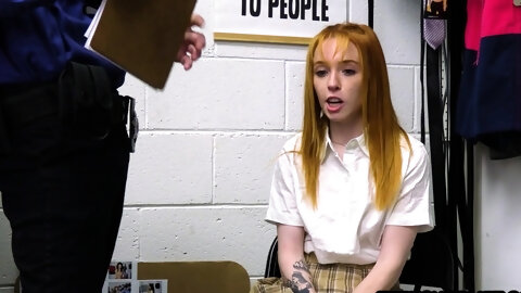 Tiny redhead teen framed by a mall cop