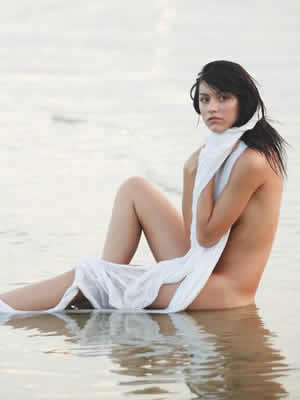 naked girl posing on the beach